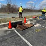 image of storm drain with grates removed and workers preparing for storm drain stabilization