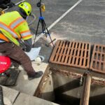 image of worker injected polyurethane during storm drain stabilization