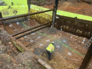 image of worker suring sinkhole stabilization project within a shoring slide rail system