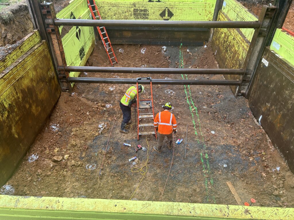 trenching with siderails and workers inside during a sinkhole stabilization project