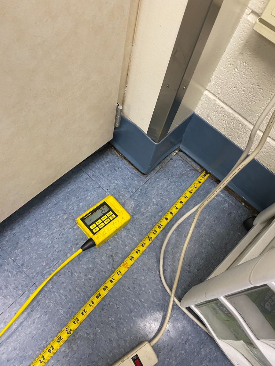 image of measurements being taken with tape measure during concrete floor slab lifting project